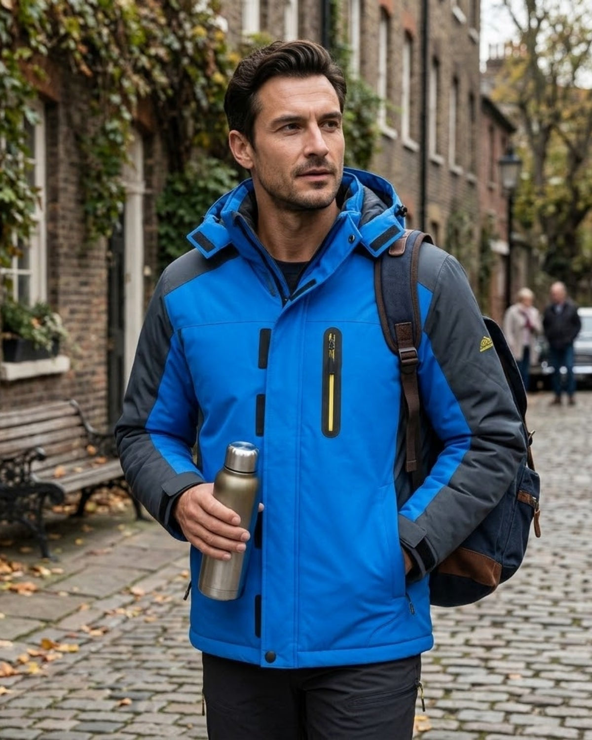 Man walking in city wearing insulated cold-weather winter jacket with backpack and thermos.