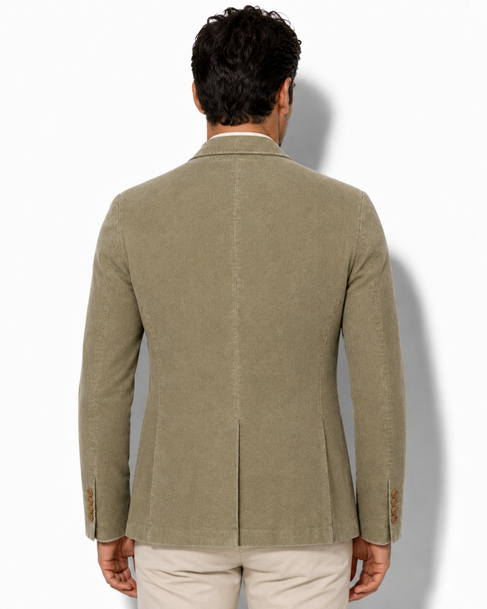 Back view of the green corduroy blazer on a model, highlighting the classic single center vent and flawless shoulder drape.